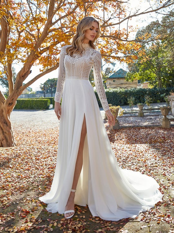 A classic A-line gown crafted in dreamy layered chiffon and heirloom lace with a sensual front split and dainty row buttons slithering down the back.   