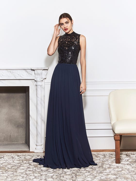 Hundreds of glittering, black sequins curl about the netted bodice of this combination sheath gown, which features a posh turtleneck accent, diamond keyhole back, and a navy blue sheath skirt in silky chiffon. 