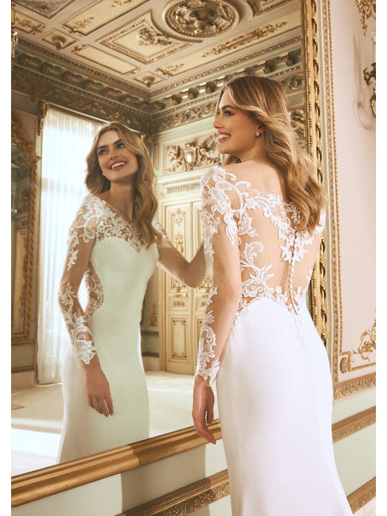 The magic of illusion tulle creates a spectacular tattoo back matching the long sleeves and the detail of the train. A crepe design that accentuates your femininity with the sweetheart neckline and slims your figure with the mermaid cut. 