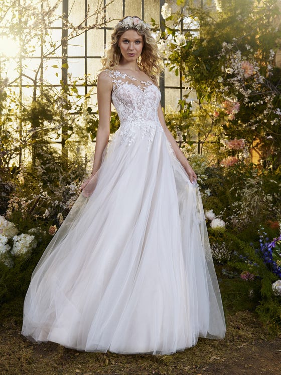Flowers wrap around the bodice of this wonderful flared tulle dress with lace and beading. It has an asymmetrical illusion neck design full of petals and floral elements that cascade to the waist, creating a dégradé effect. 