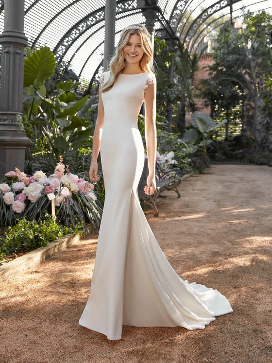 A fluid skirt in silky crepe has a high glamor factor in this mermaid-style dress that has an irresistible semi-nude back clustered with delicate beadwork, and sweet little cap sleeves.  