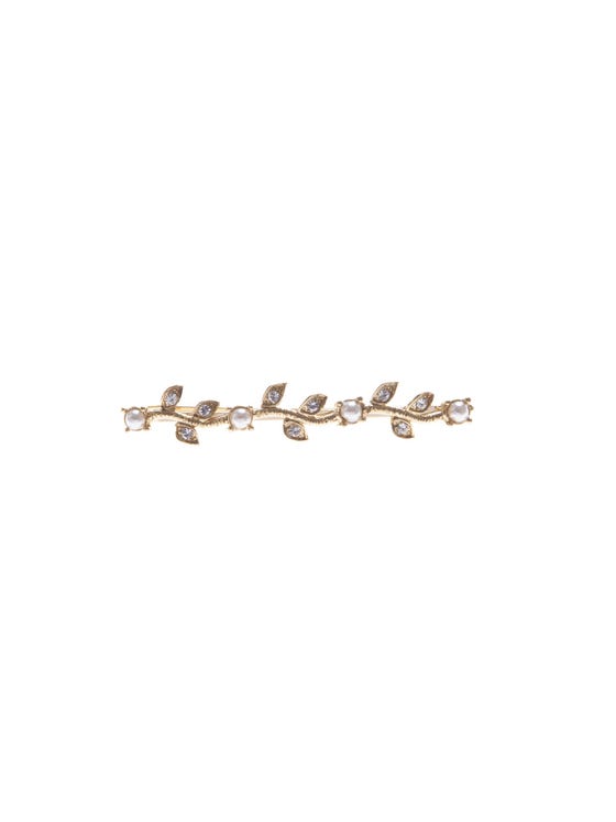 Metal clip inspired by natural motifs with beading and pearl details. 