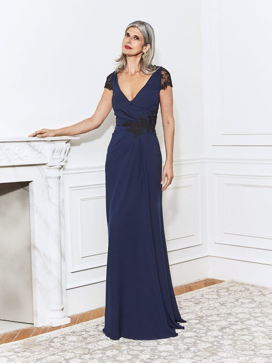 Elegant gown in navy crepe, with beautiful cuts of black, floarl lace on the cap sleeves and gathered waistline, seamlessly uniting  fitted bodice with relaxed, sheath skirt. 