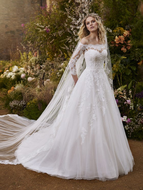 Wonderful tulle and lace dress with a flattering off-the-shoulder neckline and beautiful three-quarter illusion sleeves matching the back. A play of flowers and beading wrapping around an elegant, very romantic silhouette. 