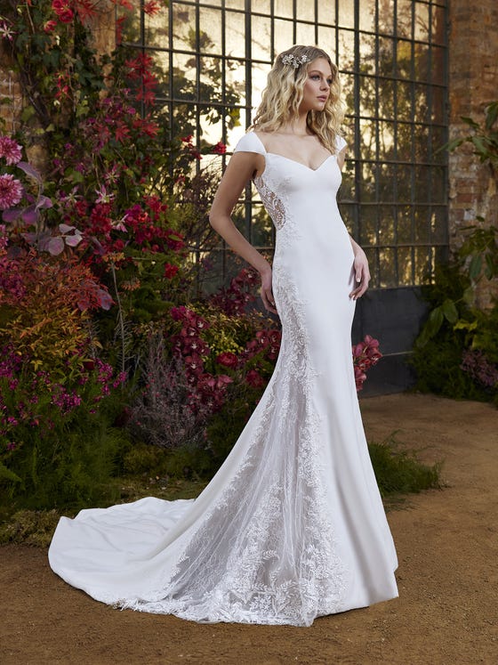 Delicate, elegant and extremely romantic. An ideal dress for a bride seeking a minimalist yet provocative look. Crepe combines and contrasts with lace transparencies and an illusion effect along the sides and back. It enhances a slender silhouette and highlights the neckline with wide straps. 