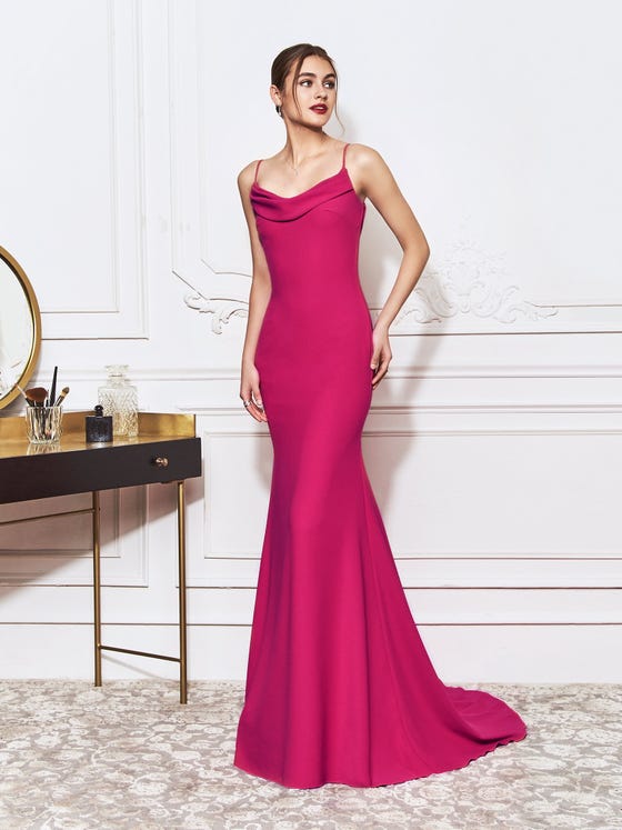 Mermaid gown in statement fuschia, crafted from irrisistable crepe that hugs the hips and lightly drapes at the spaghetti strap neckline and lovely open back. 