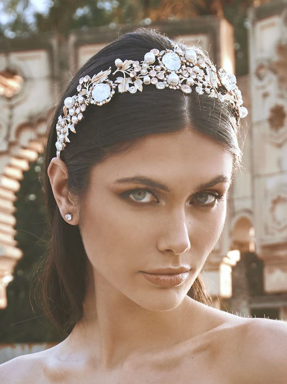 Wide metal diadem created with intertwined floral elements, enhancing the hairstyle and bringing sparkle to the headpiece. 