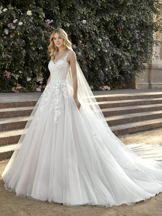A stunning princess-style gown made of layer-upon-layer of soft tulle embellished with floral embroidery on the upper skirt and bodice. With lacey straps and a perfect sweetheart neckline.  