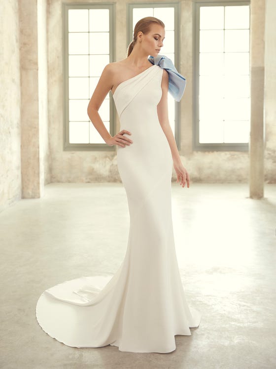 A flattering fit and flare style with a striking, detachable shoulder accent and train. Crafted in soft, fluid crepe that drapes beautifully over the body to create an elegant silhouette.  