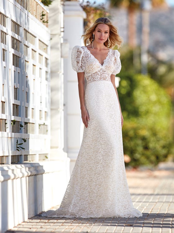 Beautiful lace dress with an A-line silhouette, V-neck front and back and romantic short puffy sleeves. 