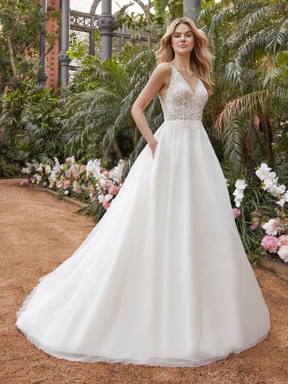 Fine, crisp organza lends featherweight form to this princess-style dress with a billowing skirt. The lace-embellished bodice has a deep V neckline and nearly-nude inserts.  