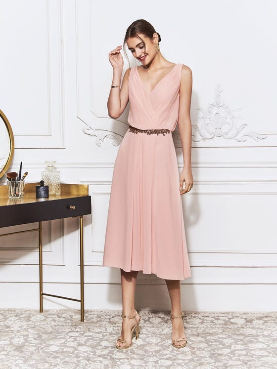 Graceful midi dress in soft pink chiffon, designed with a loosely draped crossover bodice, a fitted waistline and a relaxed, sheath skirt.  