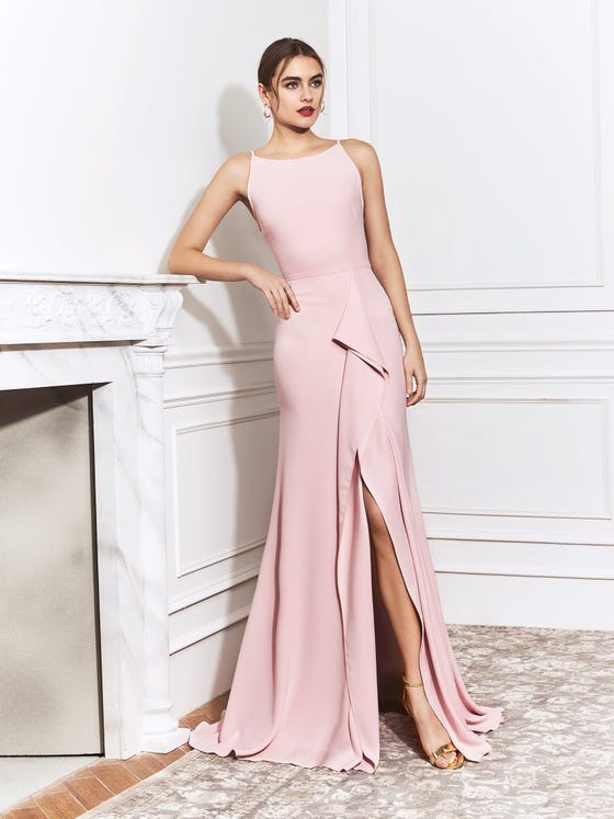 Exquisite gown in luxurious, pale pink crepe, cut with barely-there shoulder straps, a high neckline, tight waistband, and innovative, waterfall ruffle to split the mermaid skirt.  