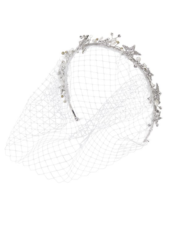 Delicate birdcage with white netting and headband of silver wiring, rhinestone buds, and glittering stars 