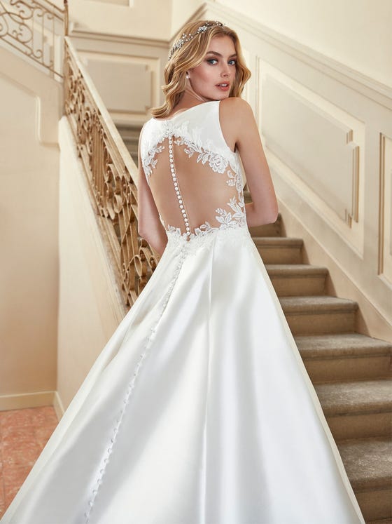 The back has it in this stunning princess gown tailored in glossy Mikado and featuring a head-turning train edged in rich scalloped lace with a matching illusion back and side inserts.  