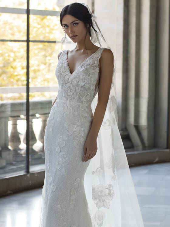 A flowing veil in tissue-soft tulle is embellished with lace applique and tiny beads for a thoroughly romantic look.  