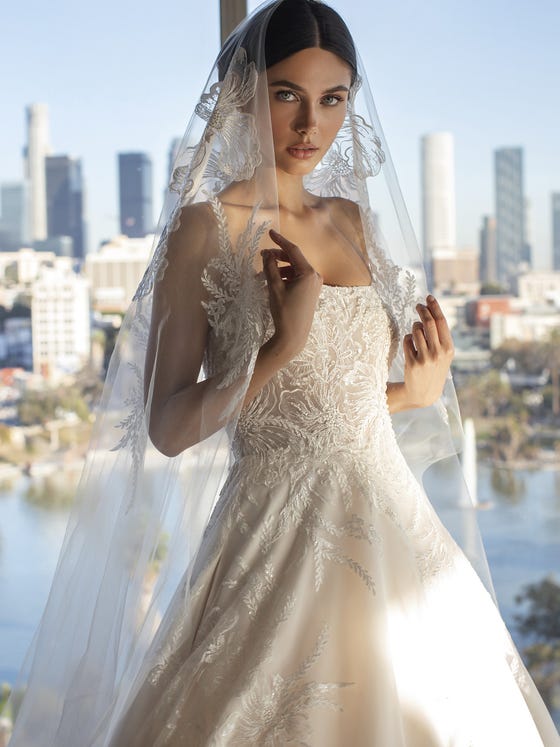 This beautiful veil with antique stylings has floral bouquet applique placement and tiny diamantes sewn into flowing tulle.  