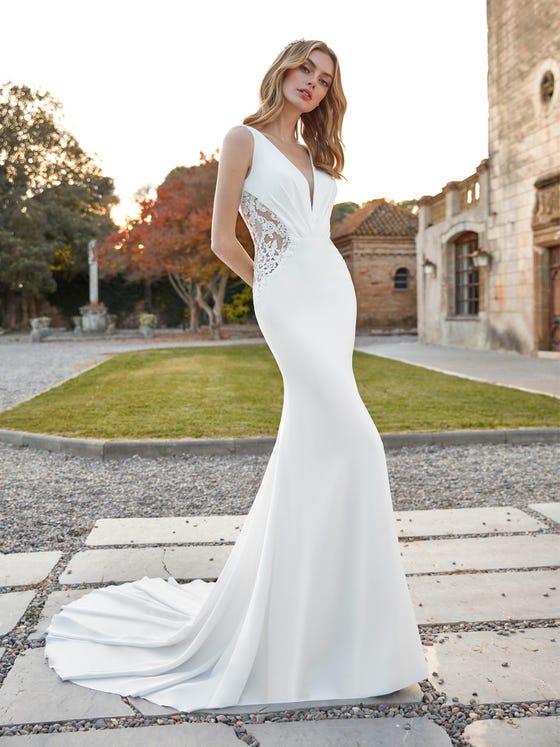 An ultra-glam Hollywood-style wedding gown in pure crepe with soft folding over the bodice and lace inserts on the side bodice.  